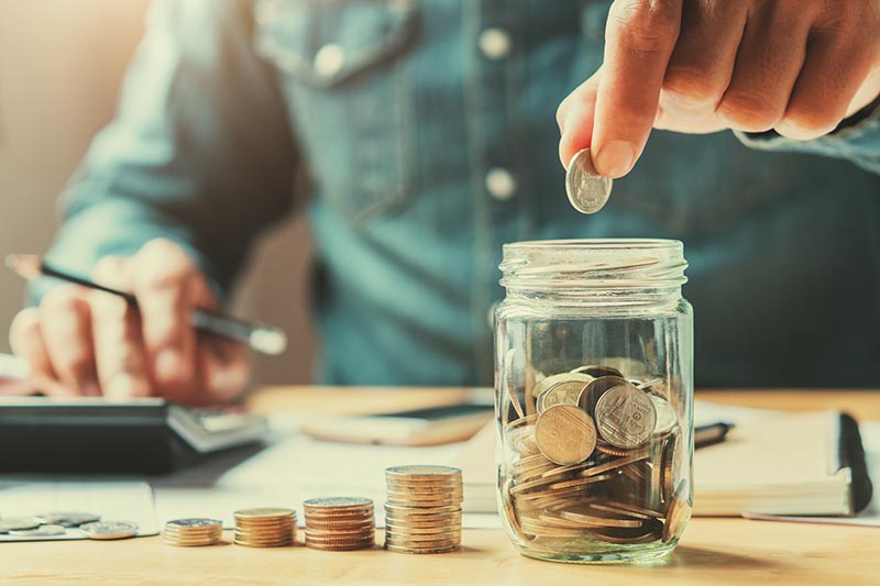 businessman-holding-coins-putting-glass-concept