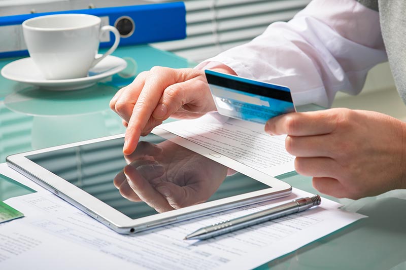 woman-using-credit-card-digital-tablet